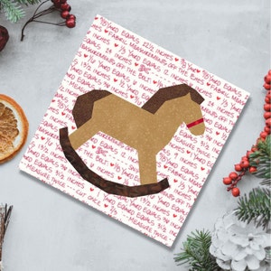 Rocking horse quilt block pattern, brown and red rocking horse on multicolored background