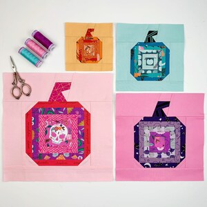 log cabin pumpkin quilt blocks in teal, pink and orange colors on mint, rose and orange background.log cabin pumpkin quilt block pattern in 5 different sizes, from 4x4 inch for ornaments to 6x6, 8x8, 10x10 and 12x12 inches for all sorts of amazing Halloween sewing projects. Use your favorite fabrics to fussy cut the center and turn these amazing beauties into your own pumpkin patch.