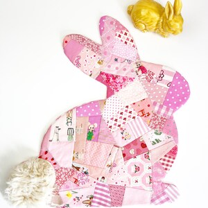 bunny shaped placemat and coaster sewing pattern, sewn with fabric scraps in pink with a fake fur little tail.