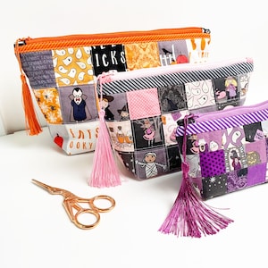 Patchwork zipper pouch sewing pattern in three sizes, the pouches are patchwork pouches, sewn with small fabric squares and contrast binding along the zipper with matching zippers. Zipper pouch sewing pattern