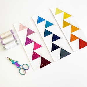 offset Flying geese quilt blocks in pinks, blues and yellows. These Jumping flying geese are perfect for quilt borders, and to enhance any quilt block.