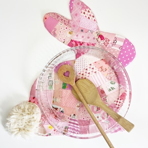 bunny shaped placemat and coaster sewing pattern, sewn with fabric scraps in pink with a fake fur little tail.