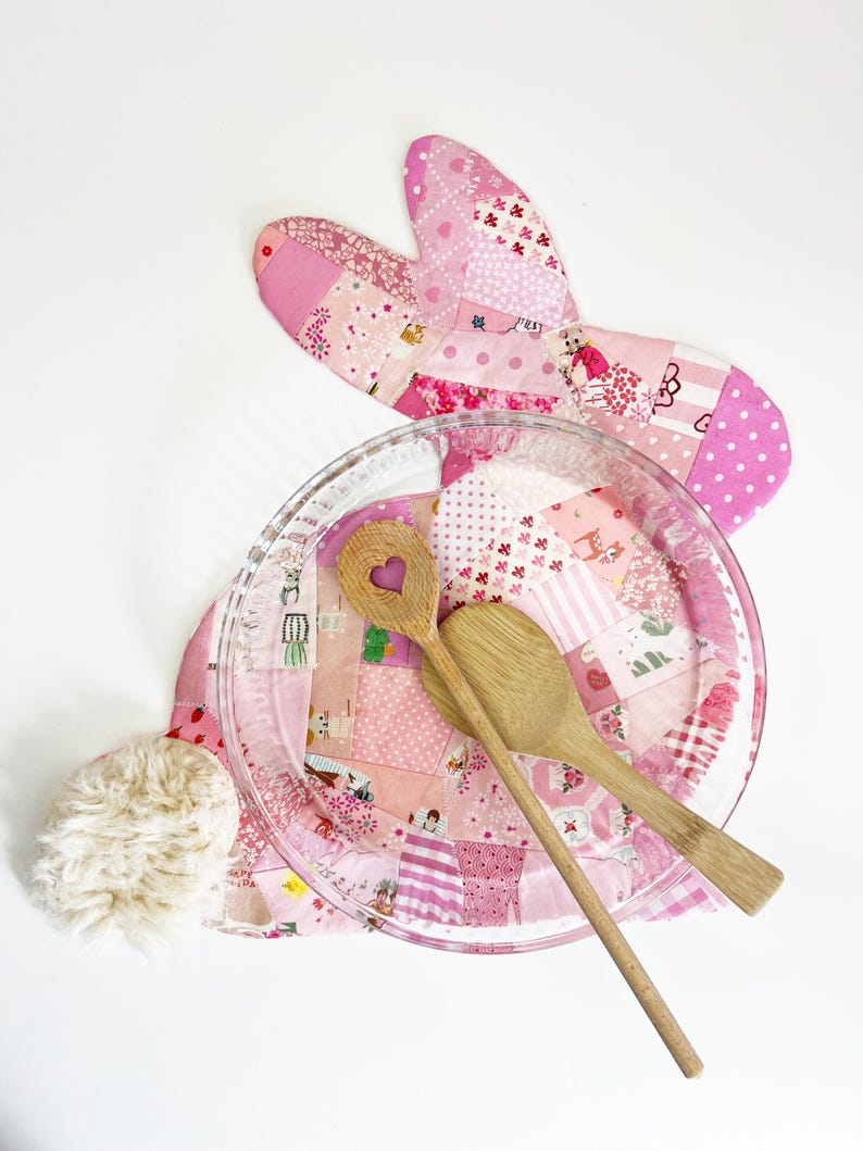 bunny shaped placemat and coaster sewing pattern, sewn with fabric scraps in pink with a fake fur little tail.