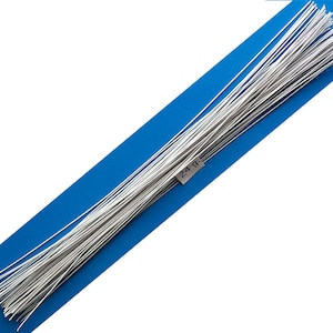 May include: A bundle of silver-colored floral wire on a blue background. The wire is approximately 24.9 grams.