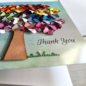 May include: A handmade thank you card featuring a colorful paper butterfly tree with the words "Thank You" printed below.