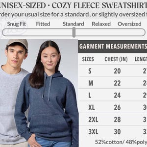 May include: A size chart for unisex fleece sweatshirts featuring a fit scale from snug to oversized. A table lists flat garment measurements in inches for sizes S through 3XL, including chest and length, with a 52% cotton and 48% polyester fabric blend.