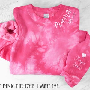 May include: Hot pink tie-dye sweatshirt with white embroidered text reading "mama est. 2025" and "Raycee Duke" with a heart. The sweatshirt has a crew neck and long sleeves. The bottom of the image reads "HOT PINK TIE-DYE | WHITE EMB."