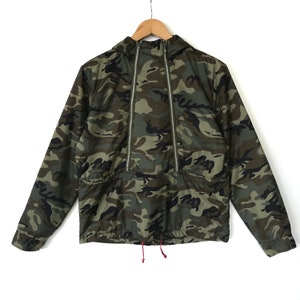 May include: A camouflage green hooded jacket with a zipper closure and a drawstring at the bottom.