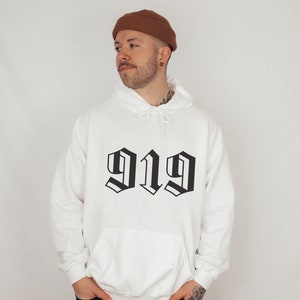 May include: White hooded sweatshirt with a black graphic of the number 919 in a gothic font.