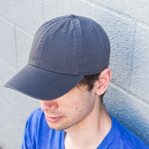 May include: A dark gray baseball cap with a curved brim. The cap is made of a soft, cotton fabric.