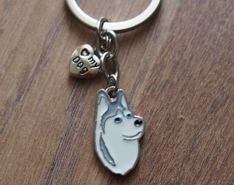 May include: A silver key chain with a white husky dog charm and a small silver heart charm that says "my dog".
