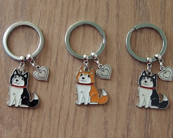 May include: Three silver keychains with a small heart charm and a cartoon husky charm. The huskies are black and white, orange and white, and black and white.
