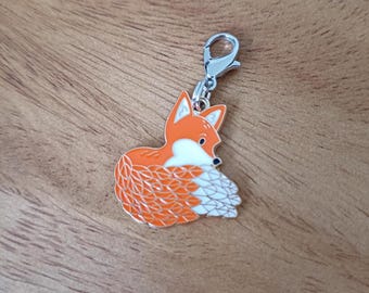 May include: A detailed orange and white fox charm with a silver clasp. The fox charm has a detailed design with orange fur and white accents. The charm is made of metal and is designed to be attached to a bracelet or necklace.