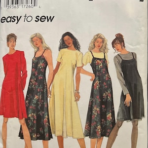 May include: Simplicity sewing pattern featuring illustrations of five dresses. The dresses include a red long-sleeve dress, a black floral print dress, a yellow dress, a black floral print dress, and a black dress with a gray long-sleeve shirt underneath. The text "easy to sew" is visible.
