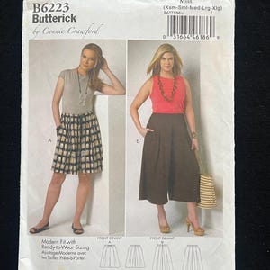 May include: A Butterick sewing pattern, B6223, featuring two women modeling different outfits. The pattern includes a skirt and culottes, with sizing from extra small to extra large. The cover has the text "Modern Fit with Ready-to-Wear Sizing."