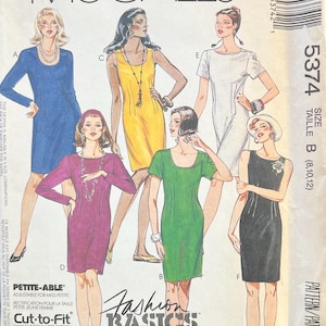 May include: A sewing pattern for five different dress styles. The pattern is called "Easy McCall's Fashion Basics" and is for size B (8, 10, 12). The pattern includes a petite-able option, which is adjustable for petite sizes.