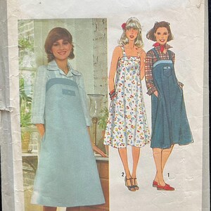 May include: Simplicity sewing pattern number 8466 for a size 10 miss. The pattern includes three different styles of dresses: a blue denim dress with a white shirt, a floral print dress, and a blue denim dress with a red plaid shirt. The pattern includes instructions for a fuss-free fit.