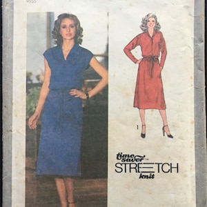 May include: Simplicity sewing pattern number 9081 for a dress. The pattern includes two different dress styles, one with short sleeves and a blue dress, and the other with long sleeves and a red dress. The pattern is for sizes 10, 12, and 14.