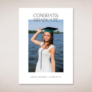 May include: A graduation announcement card with a photo of a person wearing a green graduation cap and a white dress. The text on the card reads "Congrats Graduate" and "Amelia Johnson | Class of '23".