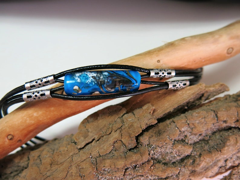 Glass beads spun with a blowtorch Murano glass. Glass ball and leather bracelet