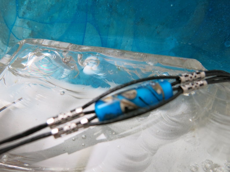 Glass beads spun with a blowtorch Murano glass. Glass ball and leather bracelet