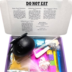 May include: A craft kit containing a black cauldron, coloured powders, glitter, a crown, wooden spoons, and vials of liquid. The box is labelled "DO NOT EAT". Measurements are not applicable.