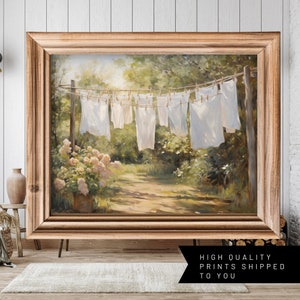 Charming laundry room art: Sheets on clothesline amid floral landscape, a modern print capturing serene spring scenery.