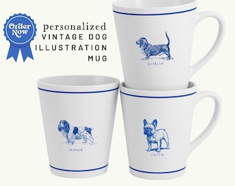 May include: White ceramic mugs with blue dog illustrations. Each mug features a different dog breed, with names like "Estelle," "Maggie," and "Lottie." The mugs have a blue rim and the text "personalized VINTAGE DOG ILLUSTRATION MUG."