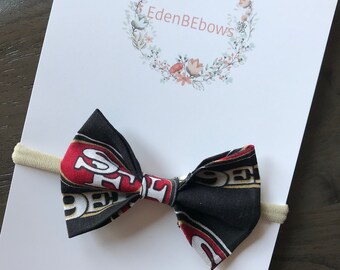 girl San Francisco 49ers headband or hair clip; football bow; 49ers fabric bow on black nylon headband or clip; niners bow; baby toddler