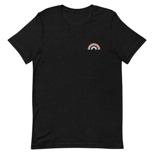 May include: A black t-shirt with a small rainbow embroidered on the front.