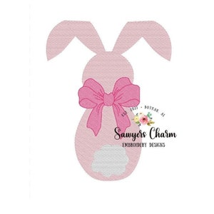 May include: Pink bunny rabbit with a large pink bow. The bunny is outlined in pink and has a white cloud-like shape in the center. The text "Sawyers Charm Embroidery Designs" is below the bunny.