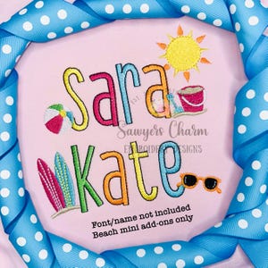 May include: A pink shirt with the names "Sara Kate" embroidered in colorful letters. The design includes a beach theme with a beach ball, surfboard, sunglasses, a bucket and shovel, and a sun.