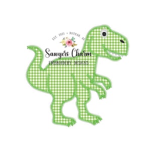 May include: Green gingham dinosaur applique embroidery design. The design features a green and white gingham pattern with a stitched outline. The dinosaur is standing with its mouth open and one eye visible. The text "Sawyers Charm Embroidery Designs" is included in the design.