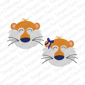 May include: Two embroidered tiger face designs featuring orange fur, light gray cheeks, dark blue noses, and black whiskers. One tiger face includes a small blue bow detail on the left ear. The embroidery is set against a repeating watermark background.
