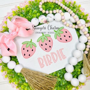 May include: A white ceramic mug with a black handle and the text "But First, Coffee" in a bold, black font. The mug is on a wooden surface. The mug is approximately 10 cm tall.