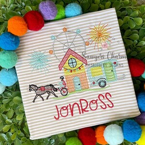 May include: Embroidered design of a carnival scene with a Ferris wheel, a house, a camper, a horse-drawn carriage, fireworks, palm trees, and the name "Jon Ross".