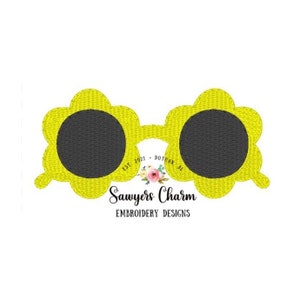 May include: Yellow flower-shaped sunglasses with black lenses. The sunglasses have a white text overlay that says "Est. 2021 - Dothan, AL" and "Sawyers Charm Embroidery Designs".
