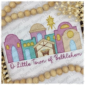 May include: Embroidered design of a small town with a star above it, with the text "O Little Town of Bethlehem".