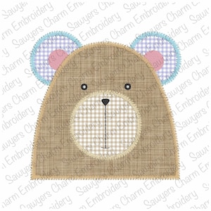May include: A brown bear applique with a white and brown gingham nose and blue and purple gingham ears. The bear has black eyes and a black nose.