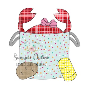 May include: A red and white checkered crab bucket with a pink bow, a brown bread roll, and a yellow and white checkered can. The bucket has a gray handle and the text "Sawyers Charm Embroidery Designs" is printed on the front.