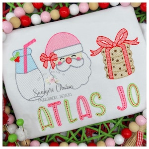 May include: Embroidered design featuring a Santa Claus, a milk bottle, a gift wrapped in a cookie, and the name "Atlas Jo".