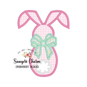 May include: Pink bunny shaped embroidery design with a green bow and a gingham pattern. The design includes the text "Sawyers Charm Embroidery Designs" and "Est. 2021 - Dothan, AL".
