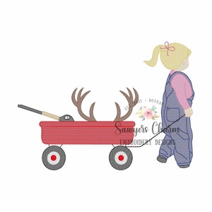 May include: A girl in overalls pulls a red wagon with a deer's antlers and a rifle inside. The wagon has black wheels and a black handle. The girl has blonde hair and is wearing a pink shirt.