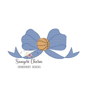 May include: Blue and white striped bow with a basketball in the center. The text "Sawyers Charm Embroidery Designs" is below the bow.