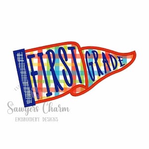 May include: A pennant-shaped design with the words "FIRST GRADE" in blue script. The pennant has a red border and a colorful plaid pattern in the background. The text "Sawyers Charm Embroidery Designs" is below the pennant.