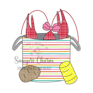 May include: A red and white checkered crawfish in a striped bucket with a pink bow. The bucket has the text "EST 2021 - DOTHAN, AL" on the side. There is a yellow and white striped cup and a brown bread roll next to the bucket.