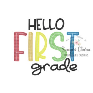 May include: Embroidered design featuring the text "Hello First Grade" in rainbow colours. The letters are outlined in white and have a stitched appearance.