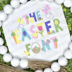 May include: Embroidered design featuring the words "The Easter Font" in a colorful, playful style. The letters are decorated with Easter-themed elements like chicks, carrots, eggs, and flowers.