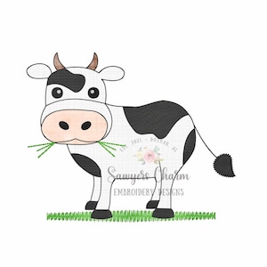 May include: A black and white cartoon cow with brown horns is eating green grass. The cow is standing on a green patch of grass. The text "Est. 2021 - Dothan, AL" is visible in the background.