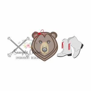 May include: Embroidered design featuring a brown bear with a red bow, two white boots with red tassels, and a pair of crossed silver baton sticks.